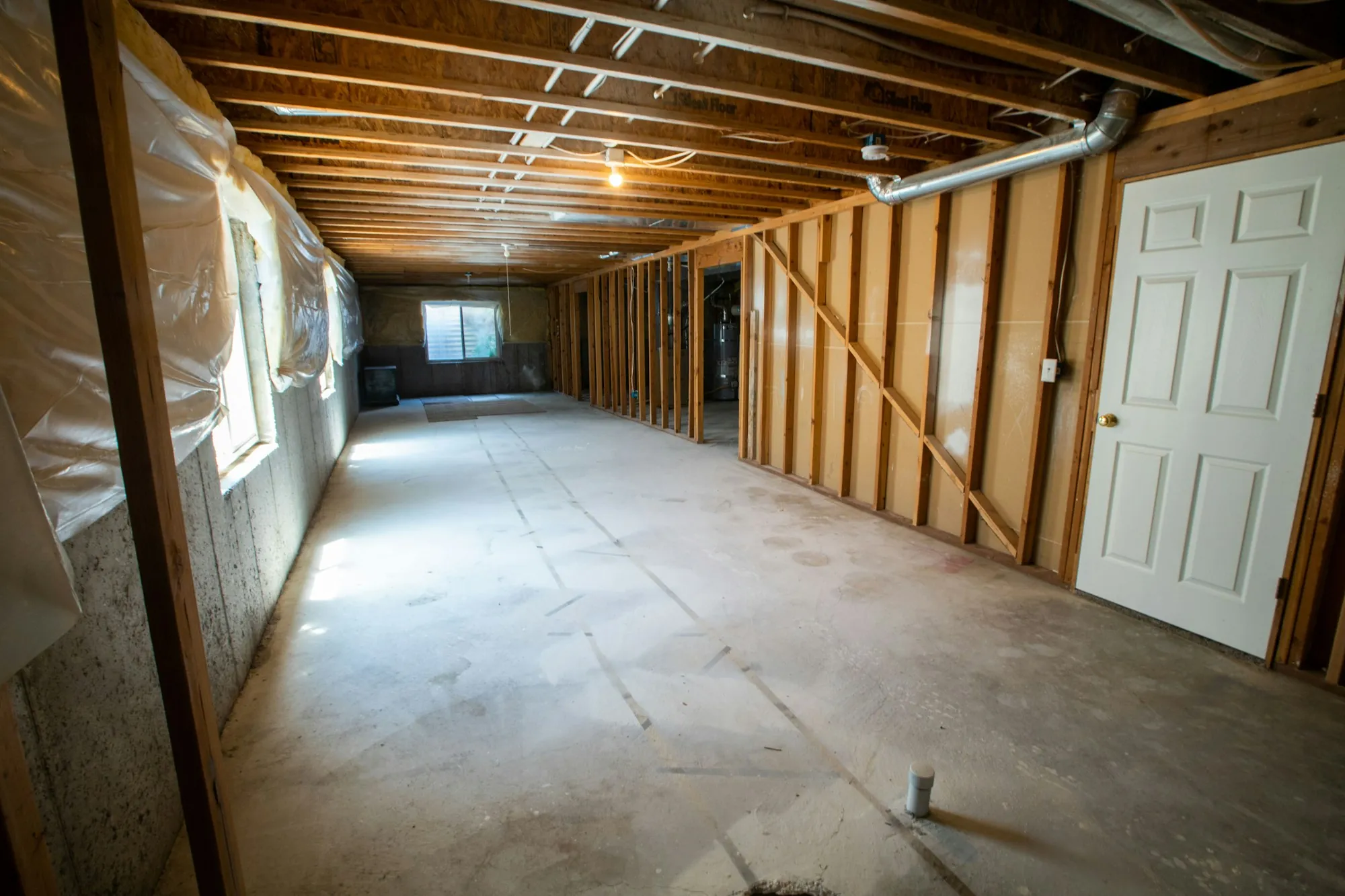 Basement with exposed joists before finishing